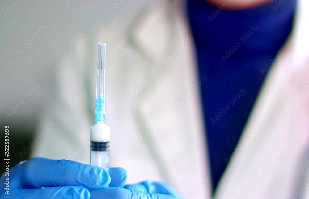 Doctor prepares injection syringe Doctor prepares injection syringe
