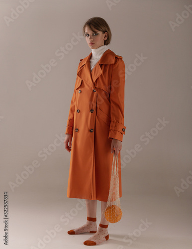  Girl in an orange trench coat with melon and lemon