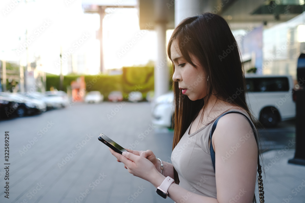Asia woman check on smart phone in car parking. Asia woman check on smart phone in car parking.