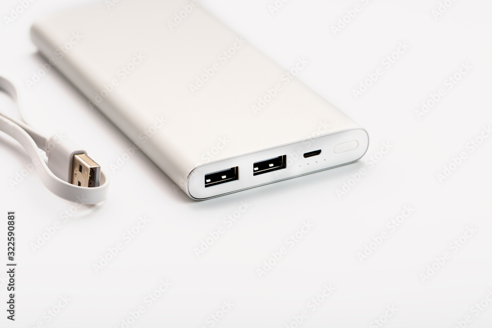 Powerbank for charging mobile devices with cable, on a white background. Powerbank for charging mobile devices with cable, on a white background.