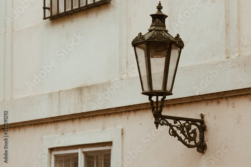 Prague. 05.10.2019: Prague street lamp. Wrought iron flashlight on the background wall of an ancient building.