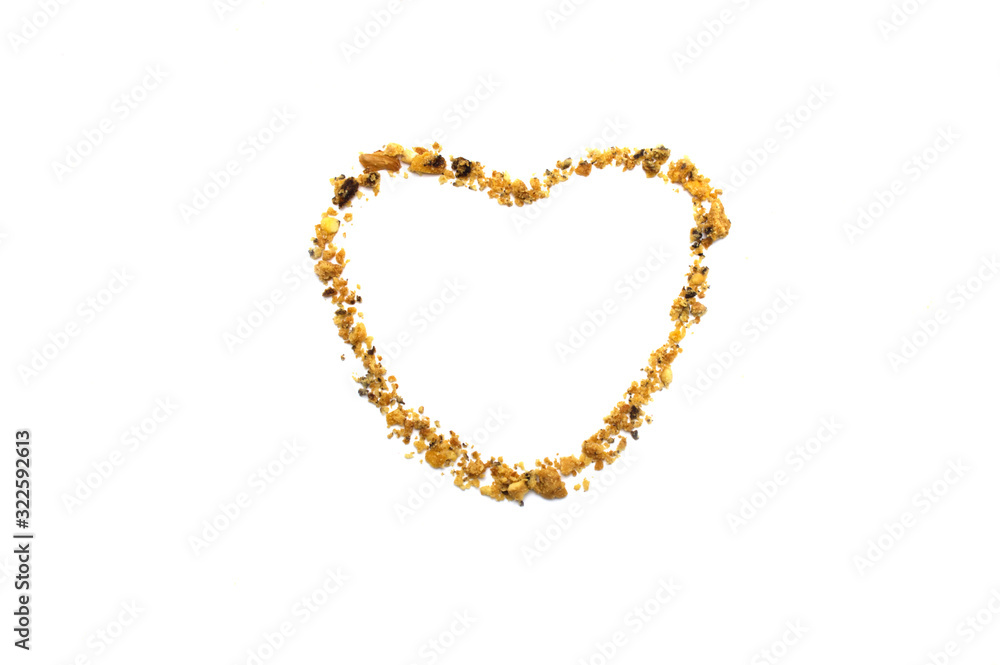 The shape of a heart line with crumbs from Homemade Oatmeal Raisin Cookies isolated on white background and copy space. The shape of a heart line with crumbs from Homemade Oatmeal Raisin Cookies isolated on white background and copy space.