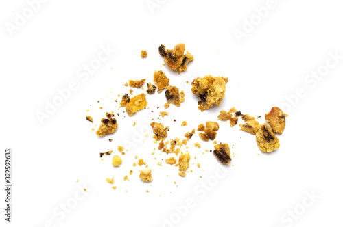 Scattered crumbs of homemade oatmeal raisin cookies isolated on white background.