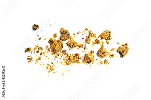 Scattered crumbs of homemade oatmeal raisin cookies isolated on white background.