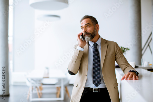 Senior businessman using mo...