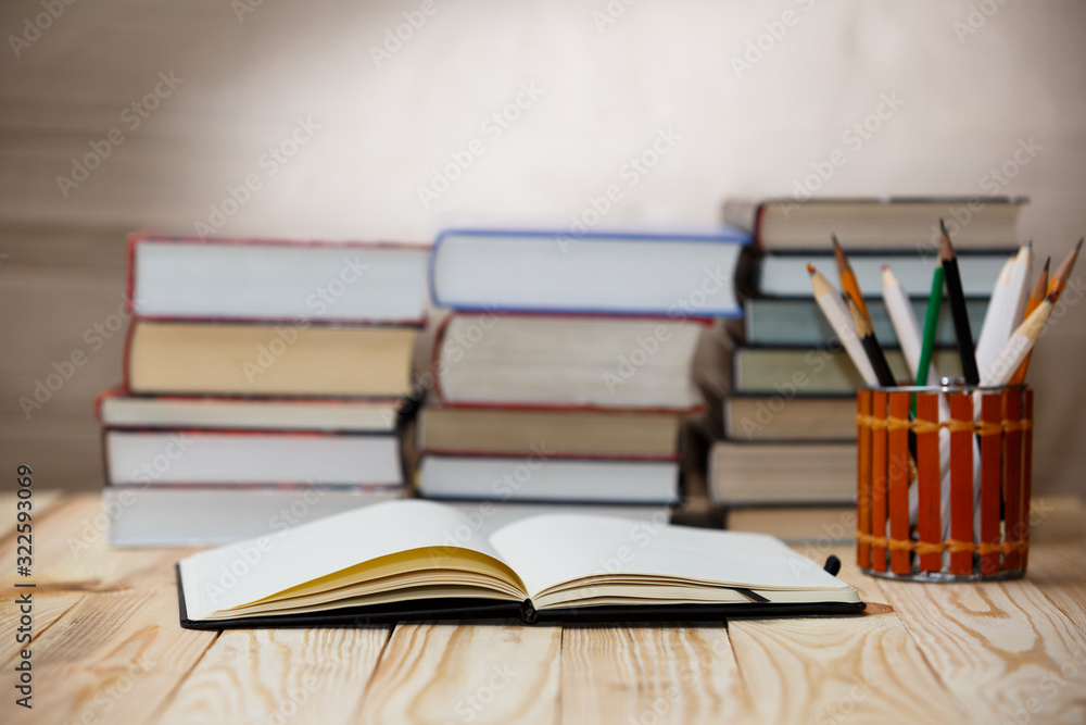 Fototapeta premium Textbooks and books on a wooden table