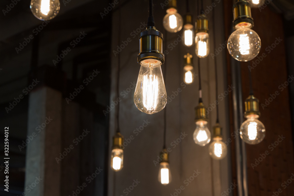 vintage light bulbs hanging from ceiling for decoration in living room.  loft decoration style. Stock Photo | Adobe Stock