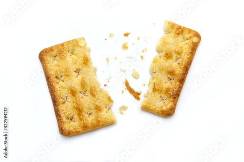 Broken square crackers biscuits isolated on white background. Crushed dry snack.