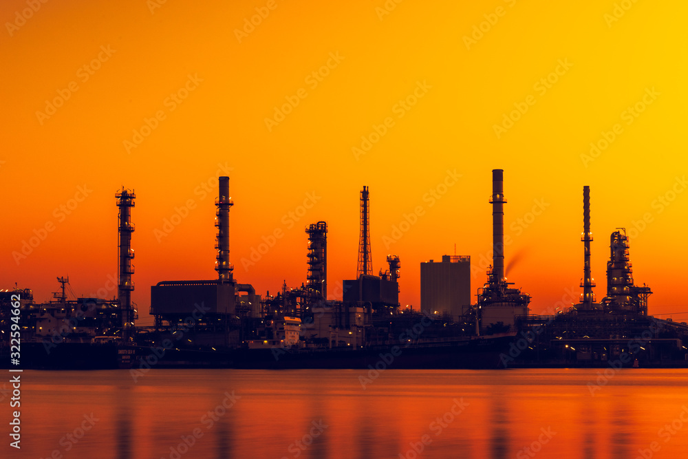 Silhouette of oil and gas refinery industry plant with glitter lighting and sunrise in the morning, Factory of petroleum industrial, Power plant,Energy power station area.