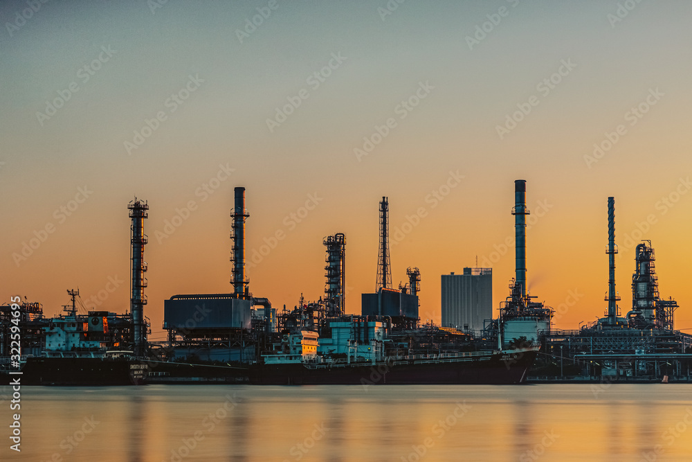 Oil and gas refinery industry plant with glitter lighting and sunrise in the morning, Factory of petroleum industrial, Per plant,Energy power station area. Industry