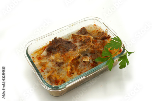 Traditional Romanian homemade pork trotter jelly dish called piftie. Jellied pork aspic made with pork meat served with paprika and fresh parsley.