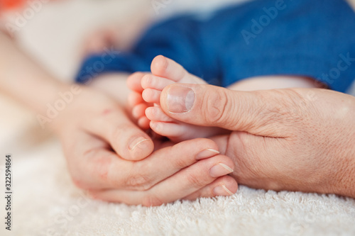 Close up photo of a baby foot in mother hands.