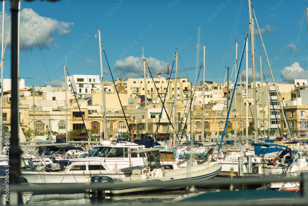 Boats in harbor of Valletta, capital of Malta. Scenic view of maltese coast with ships and traditional houses. Popular famous travel tourism destination island Malta. Sea landscape.
