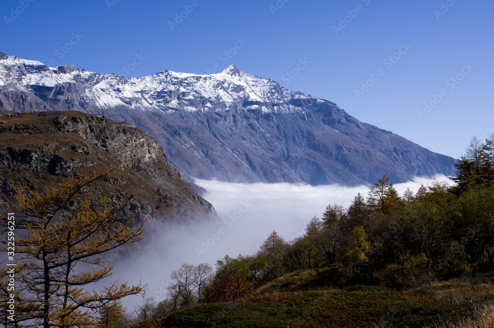 The clouds under the Rocciamelone Italy may look like a white river flowing among the mountains.