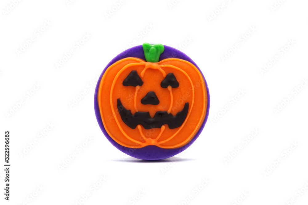 Fototapeta premium Cute Halloween Orange pumpkin chocolate cookie treat isolated on white background. Homemade biscuit for holiday festival. Treats for party.