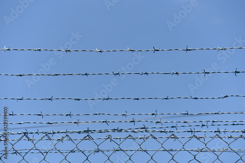 Iron barbed wire fence.Barbwire in security forbidden to entry prison military or private area.