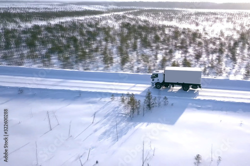Wallpaper Mural lorry with a wagon rides along the road in winter. Winter road for a truck. Torontodigital.ca