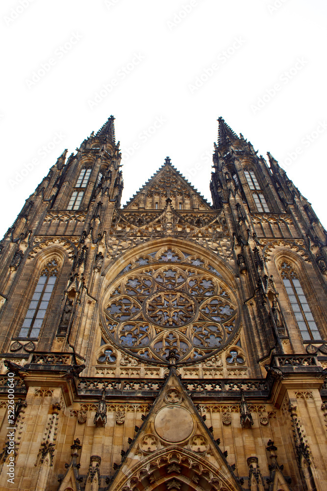 Prague. 05.10.2019: Perspective view of the Metropolitan Cathedral of Saints Vitus, Wenceslaus and Adalbert, an excellent example of Gothic architecture. Golden Gate South Tower with clock.