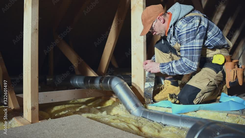 Building Residential Ventilation System. Worker Assembly Air Ventilation Pipes. House Attic. Industrial Theme. Building Residential Ventilation System. Worker Assembly Air Ventilation Pipes. House Attic. Industrial Theme.