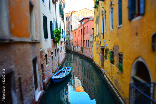 Empty Venetian boat on traditional narrow canal street, Venice, Italy