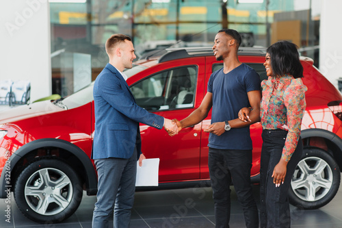 young african couple buying new car at dealership © Serhii