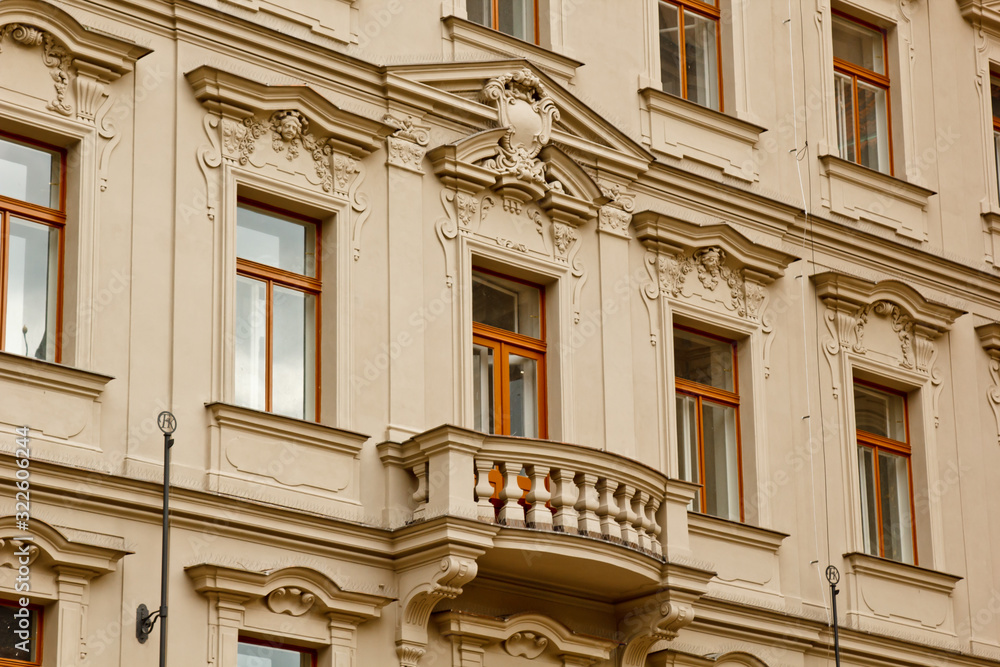 Obraz premium Prague, Czech Republic. 10.05.2019: Close-up view of the facade with windows of old historical buildings in Prague. Retro, old-fashioned, vintage, last century.