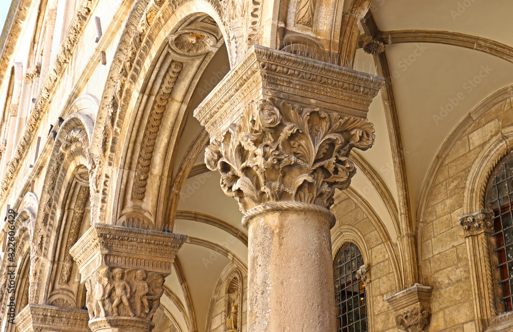 Dubrovnik, Crotia.  Architectural details of Gothic Rector's palace with Renaissance Decorative Arch and Column.   Square at Stradun Street, Old city of Dubrovnik