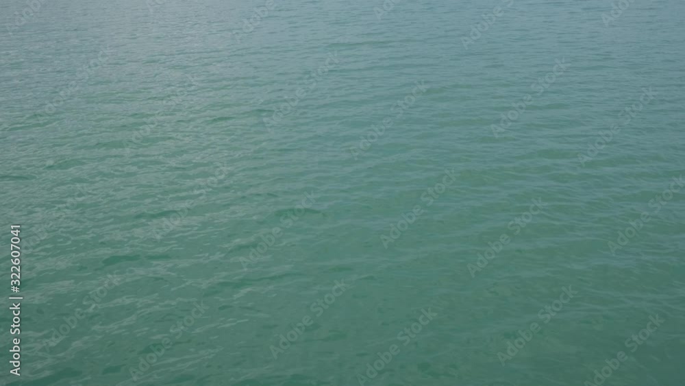 clean sea water surface flowing. reflection of sun shine. green water calm wave clean sea water surface flowing. reflection of sun shine. green water calm wave