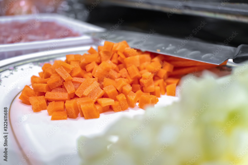 Fresh Diced Raw Carrots being Prepared. Fresh Diced Raw Carrots being Prepared.
