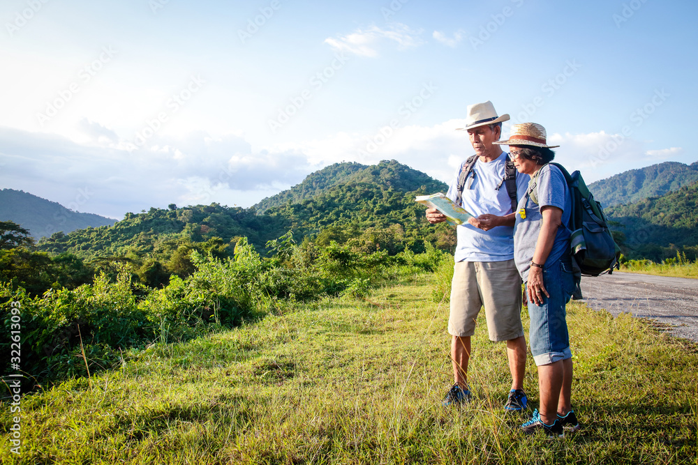 Senior Asian Couple Trekking, traveling, living a happy life in retirement Healthy, can see the fresh nature. The concept of health tourism for the elderly. with copy space.