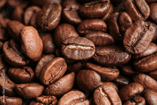 Coffee beans on the rustic wooden background. Selective focus. Shallow depth of field.