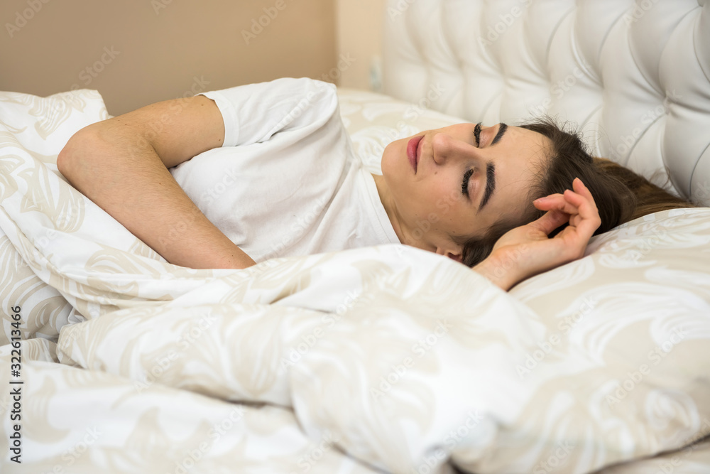 Young woman sleeping and viewing her sweet dream in bed and relaxing in the morning before work week. Healthcare and sleep concept. Young woman sleeping and viewing her sweet dream in bed and relaxing in the morning before work week. Healthcare and sleep concept.