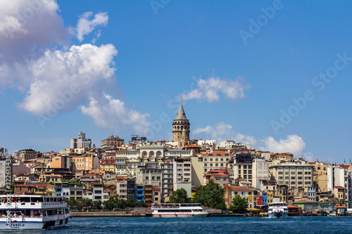 June 18  2019 - Istanbul  Turkey - View of Galata Tower from the opposite bank on the Golden Horn  ferry boats are in the foreground