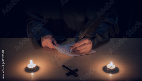 monk or priest writing. religion. hands. spirituallity. photo