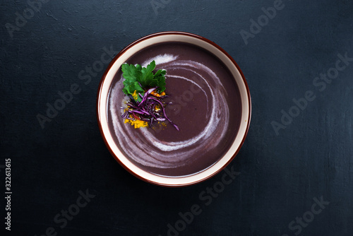 Soup of mashed potatoes, carrots, onions and red cabbage on a dark background. Place for text photo