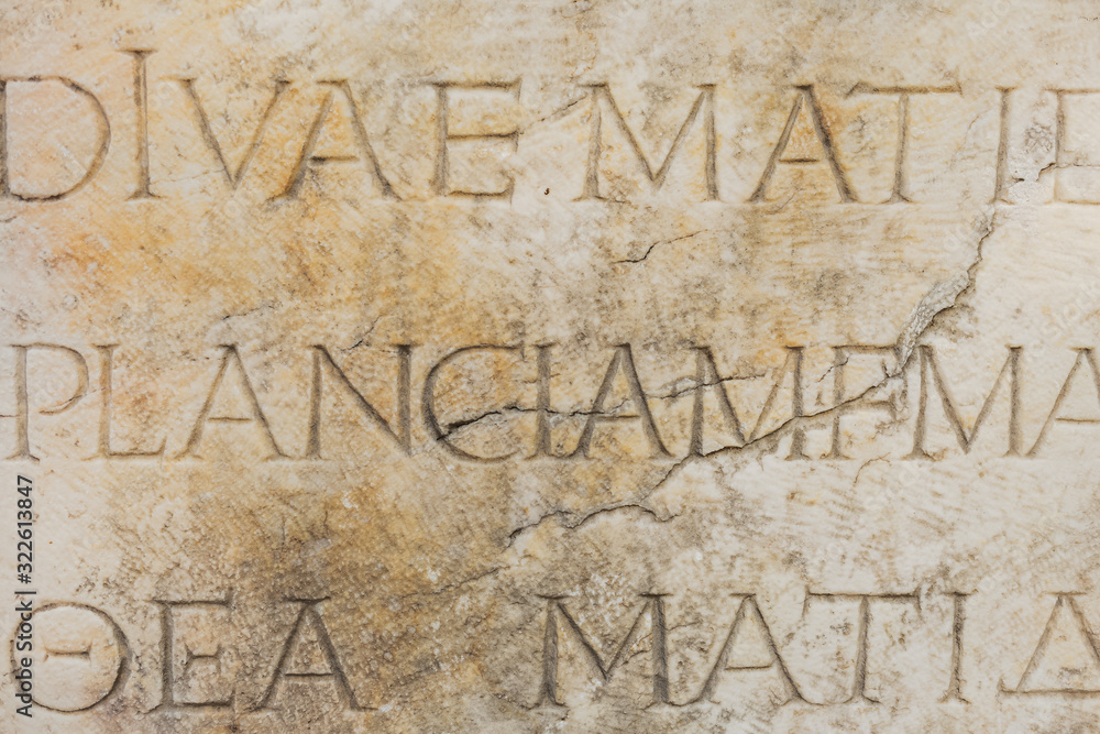 Ancient wall and letters curved in its surface. Ancient wall and letters curved in its surface.