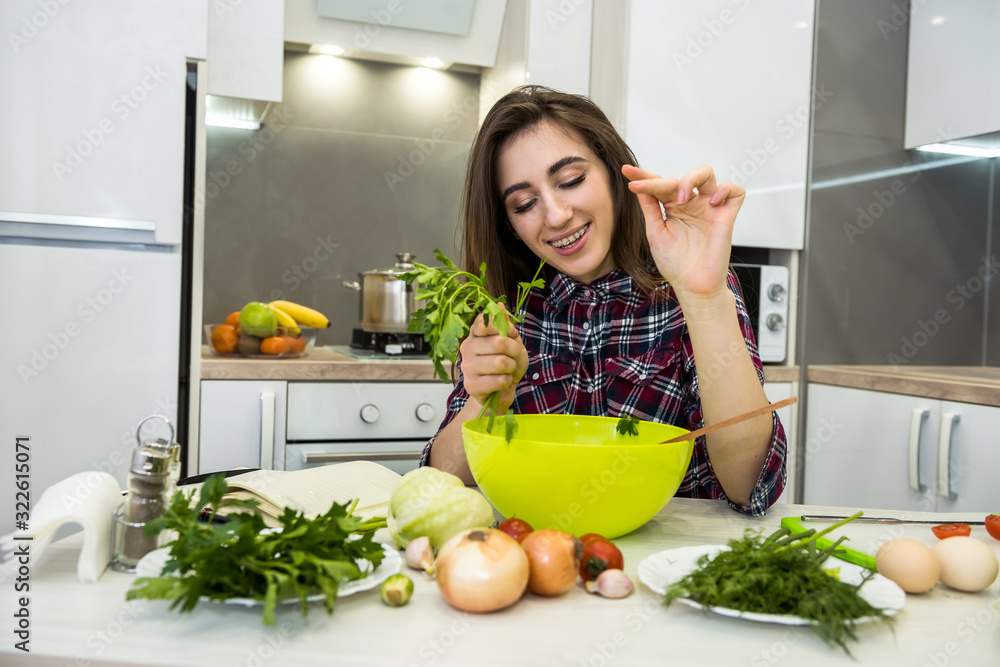 Young woman preparing dinner in a kitchen. healthy lifestyle