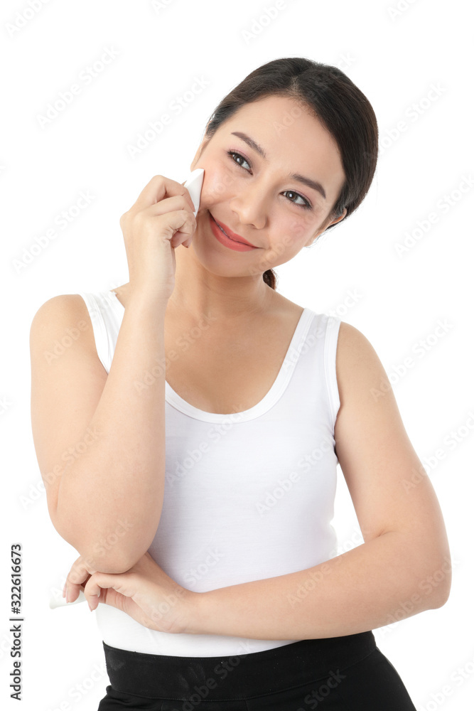 Beautiful Asian women skin treatment, use a sponge to wipe the face, beauty, attractive with a smile. White background Beautiful Asian women skin treatment, use a sponge to wipe the face, beauty, attractive with a smile. White background