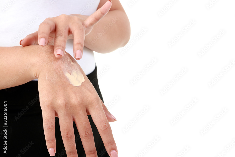 Young women apply nourishing cream to the skin on the back of the hand to be moist, not dry. Concept of beauty and health care