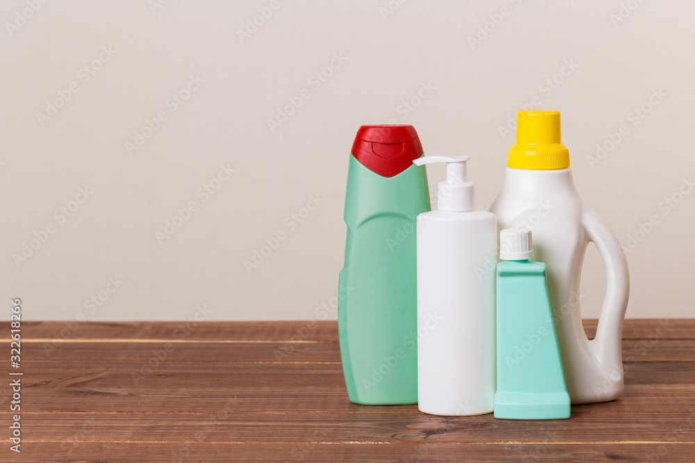 Cleaning product plastic container for house clean on wooden table and gray background . household chemicals Cleaning product plastic container for house clean on wooden table and gray background . household chemicals