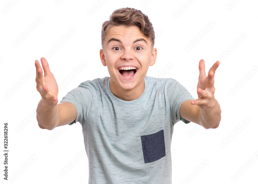 Portrait of joyful teen boy with raised hands. Handsome caucasian teenager laughing and screaming isolated on white background. Happy child exclaiming with joy and excitement, looking at camera. - obrazy, fototapety, plakaty 
