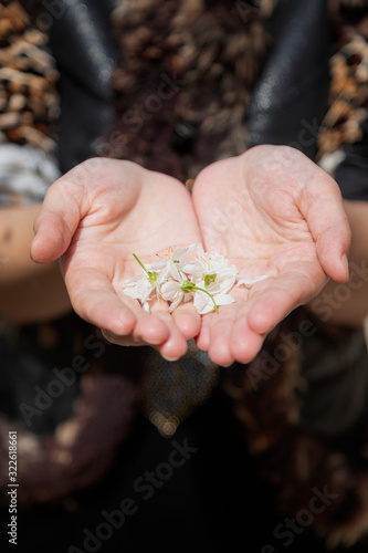 Woman holds in hands first spring tree blossoms