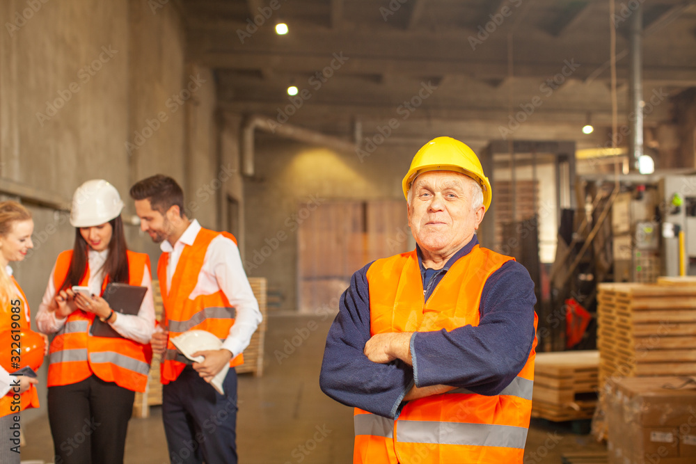 Team leader with his production group standing behind Team leader with his production group standing behind
