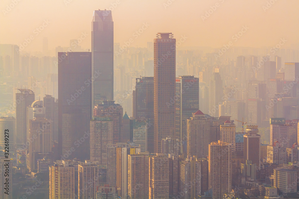 Chongqing, China - March 22, 2018: Blurred cityscape in sunset haze in the Chinese city of Chongqing. Incredible view.