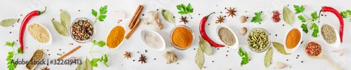 Obraz  z motywem Various assorted colorful spices and herbs on white wooden background top view. Banner size.
