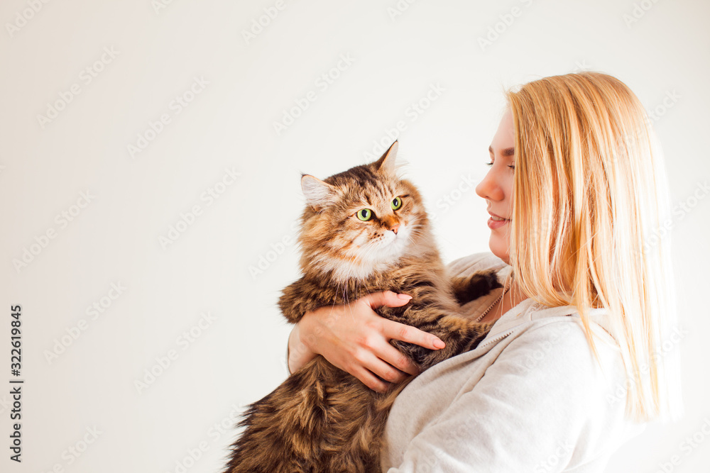 Pretty blonde lady holding cute siberian cat Pretty blonde lady holding cute siberian cat