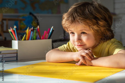 Cute face of pupil, close up. Elementary school classroom. Child home studying and home education. Schoolkid or preschooler learn. photo