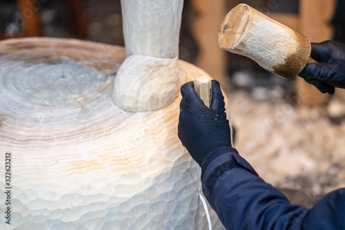Принти на полотні Wood carver working on a large sculpture of Winnie the Pooh