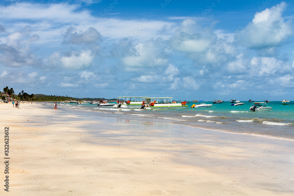 Maragogi Beach (Praia de Maragogi) with its clear water and white sand, and the boats that carry tourists to the coral reef.