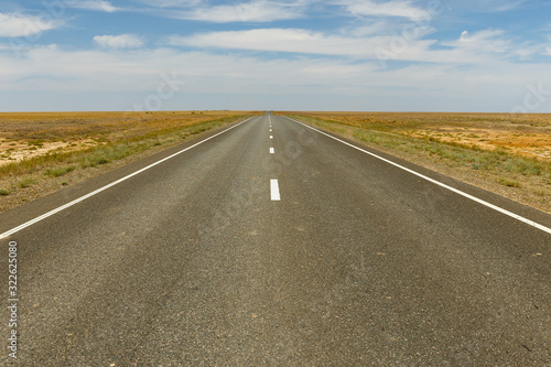 empty asphalt road across the steppe, Kazakhstan